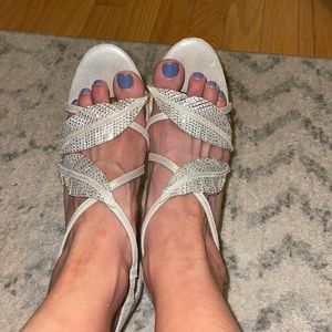 Gently used champagne color shimmer heels with sparkle leaf criss cross straps